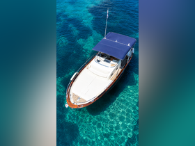 A stunning aerial view of a sleek boat cruising over crystal-clear waters, showcasing its elegant design and perfect for a day on the sea.