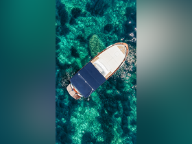 A stunning aerial view of a boat cruising over crystal-clear waters, showcasing the vibrant underwater scenery — perfect for exploring coastal destinations.