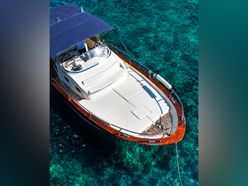 A stunning aerial view of a luxurious yacht docked in crystal-clear waters, showcasing its elegant design and spacious deck — perfect for relaxing on the water.