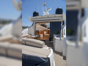 An elegant interior view of a yacht's cabin featuring comfortable seating and a dining area, perfect for relaxing and entertaining while on the water.