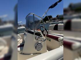 A close-up view of the helm and seating area inside a boat, showcasing the console and audio system, perfect for a day on the water.