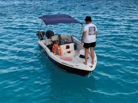 A man stands on the deck of a boat, surrounded by stunning turquoise waters, showcasing the perfect setting for a day of adventure on the sea.