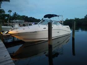 A sleek speedboat docked at twilight, reflecting beautifully in the calm waters, perfect for evening cruises or fishing trips.
