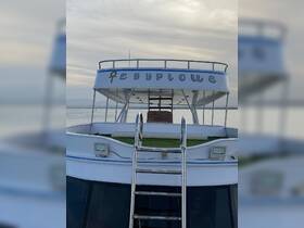 A clear view of the back of a boat named 'Egyptous', showcasing its structure and design against a serene water backdrop.