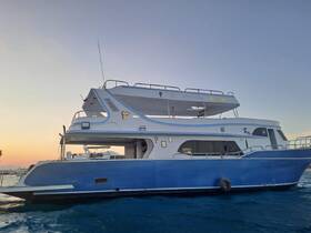 A stunning side view of a yacht docked in calm waters during sunset, showcasing its elegant design and structure.