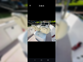 Interior view of a well-equipped boat helm featuring comfortable seating and a modern console, ideal for navigating the waters.