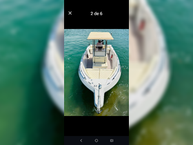Aerial view of a center console boat with a captain at the helm, gliding through clear waters — perfect for fishing or day trips on the water.