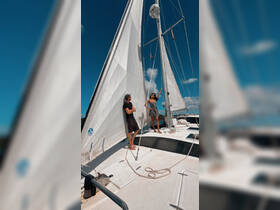 A couple enjoys a sunny day sailing on a catamaran, showcasing the perfect blend of adventure and relaxation on the water.