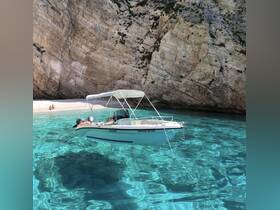 A sleek speedboat anchored in crystal-clear waters near a secluded beach, with stunning rocky cliffs in the background — perfect for exploring hidden coves.