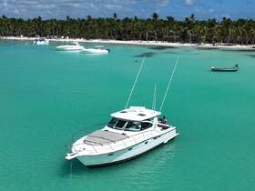 A stunning aerial view of boats anchored in crystal-clear turquoise waters, surrounded by a beautiful beach and palm trees — perfect for a tropical getaway.