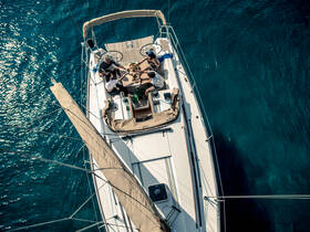 A lively group enjoys drinks and camaraderie aboard a sailboat, capturing the essence of a fun day on the water.