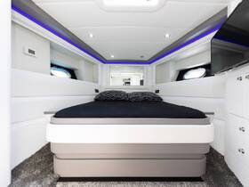 A modern and stylish cabin interior featuring a comfortable bed and sleek design elements, perfect for relaxing on a boat getaway.