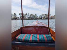 A cozy interior view of a boat showcasing comfortable seating, perfect for relaxing while enjoying a scenic ride on the water.