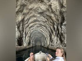 A thrilling boat ride through a stunning cave, showcasing the unique rock formations and the excitement of exploration with friends.