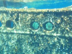 An underwater image of a submerged structure, possibly a wreck, with unclear visibility — intriguing for diving enthusiasts exploring marine history.