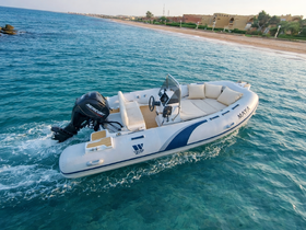 A sleek speedboat named 'MAYA' glides through clear turquoise waters, showcasing its elegant design and perfect for leisurely outings.