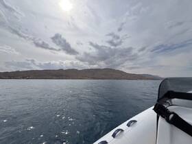A scenic view from a boat showcasing the tranquil waters and distant land, perfect for exploring coastal landscapes.