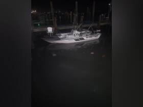 A sleek Skeeter boat docked at night, reflecting the surrounding lights in the calm water — perfect for evening fishing trips or leisurely cruises.