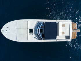 Aerial view of a sleek speedboat showcasing its elegant design and spacious deck, perfect for cruising on open waters.