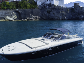A sleek speedboat glides through clear waters, showcasing its elegant design and perfect for thrilling adventures on the sea.