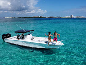 A couple joyfully jumps off a boat into the stunning turquoise waters, capturing the essence of adventure and fun on a perfect day at sea.