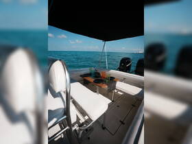 A cozy dining area inside a boat, featuring colorful glasses and plates, perfect for enjoying meals while out on the water.