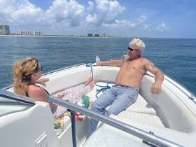 A couple enjoys a relaxing day on the boat, soaking up the sun and the ocean views — perfect for a leisurely getaway.
