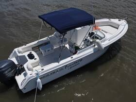 A well-maintained center console boat, the Sea Hunt, is docked and ready for adventure on the water, showcasing its spacious seating and sleek design.
