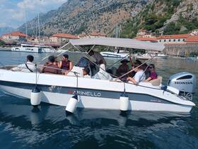 A lively group enjoys a day on the water aboard a Marinello boat, surrounded by stunning coastal scenery. Perfect for exploring the beautiful bays and enjoying time with friends.