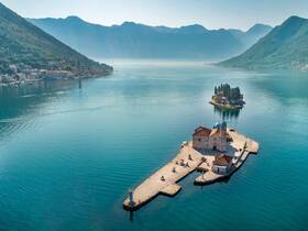 A stunning aerial view of picturesque islands and a serene coastline, showcasing the natural beauty of the landscape — perfect for travelers seeking scenic boat tours.