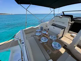 A beautifully set dining area on a boat, featuring plates and glasses ready for a meal, perfect for enjoying gourmet experiences on the water.