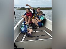 A group of children enjoys a fun moment aboard a boat, showcasing the joy of boating adventures with friends.