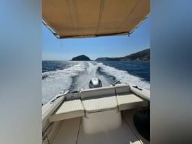 A view of the boat's interior seating area, showcasing a comfortable helm and spacious layout, perfect for enjoying a day on the water.