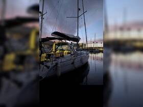 A serene evening view of a yacht docked in the marina, showcasing its elegant design against a colorful sunset sky.