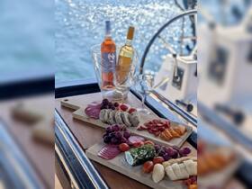 A beautifully arranged charcuterie board featuring assorted meats, cheeses, and wines, perfect for enjoying a luxurious day on the water.