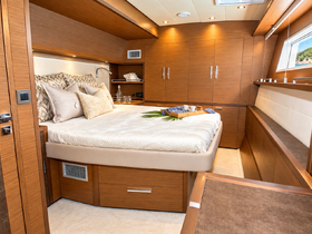 A beautifully designed cabin interior featuring a cozy bed and elegant decor, perfect for relaxing on a luxury yacht.
