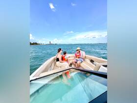 A family enjoys a relaxing moment on a boat, with children present, capturing the joy of a day on the water.