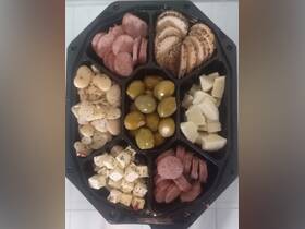 A beautifully arranged charcuterie platter featuring a variety of meats, cheeses, and olives, perfect for onboard dining or entertaining guests.