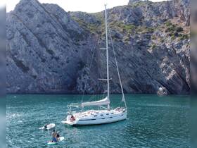 A group enjoys a day of paddleboarding and sailing near stunning rocky cliffs, showcasing the perfect blend of adventure and natural beauty.