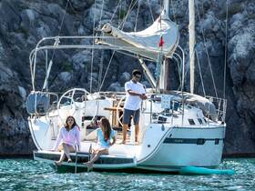 A lively group enjoys a day on a sailboat, relaxing and having fun in the water, showcasing the perfect blend of adventure and leisure.