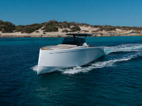 A sleek speedboat glides through crystal-clear waters, showcasing its modern design and performance on a sunny day.