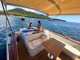 Two friends enjoy a relaxing day on the boat, sunbathing and taking in the beautiful scenery — a perfect getaway for summer fun on the water.