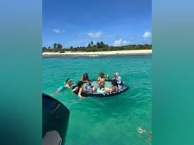 A joyful group enjoys a fun day in the water, relaxing on a floating mat while soaking up the sun at a beautiful beach destination.
