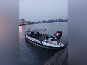 A group of guests disembarks from a boat at dusk, surrounded by stunning scenery — perfect for evening adventures and exploring the coastline.