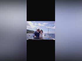 A couple enjoys a scenic boat ride on the ocean, capturing a moment of joy and adventure amidst beautiful surroundings.