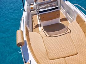 A stylish interior view of a boat showcasing plush seating and a well-designed helm, perfect for comfortable cruising on the water.