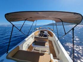 A beautifully designed helm area of a boat, showcasing comfortable seating and a well-equipped console, perfect for a day on the water.