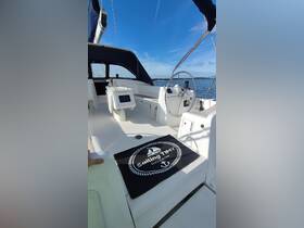 A well-equipped helm area of a sailing yacht, featuring comfortable seating and a welcoming mat, perfect for enjoying a day on the water.