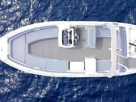Aerial view of the spacious interior of a boat, showcasing comfortable seating and the helm area, perfect for relaxing on the water.