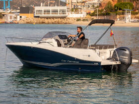 A man navigates a Cap Camarat boat through clear waters, showcasing the perfect blend of adventure and relaxation on the water.